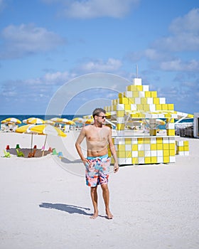 Miami beach, young men on the beach at Miami beach, lifeguard hut Miami beach Florida