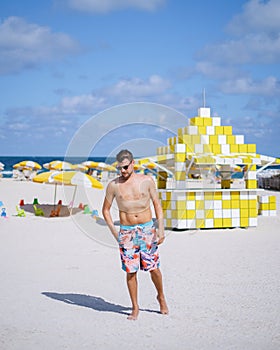 Miami beach, young men on the beach at Miami beach, lifeguard hut Miami beach Florida