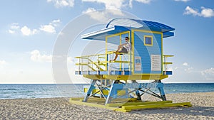 Miami beach, young men on the beach at Miami beach, lifeguard hut Miami beach Florida during sunrise