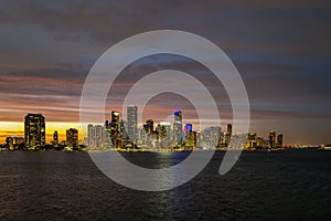 Miami city. Miami skyline panorama at dusk with skyscrapers over sea. Night downtown sanset.