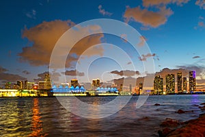 Miami city. Miami skyline panorama at dusk with skyscrapers over sea. Night downtown sanset.