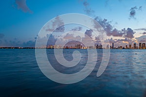 Miami city. Miami skyline panorama at dusk with skyscrapers over sea. Night downtown sanset.