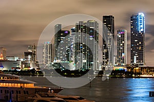 Miami city night. Miami Florida at sunset, skyline of illuminated buildings and Macarthur Causeway bridge.