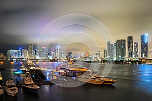 Miami downtown. Beautiful colorful city of Port Miami Florida, skyline and bay with night clouds.