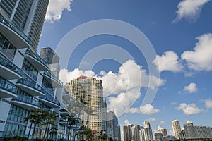 Miami, Florida cityscape with luxury condominiums against the puffy clouds in the sky- Miami, FL