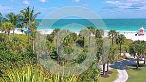 MIAMI, FLORIDA, USA - MAY 2019: Aerial drone panorama view flight over Miami beach. Sand, palm trees and sea from above.