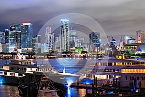Miami night downtown. Miami Florida at sunset, skyline of illuminated buildings and Macarthur Causeway bridge.