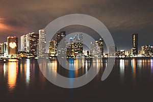 Miami skyline. Miami Florida, sunset panorama with colorful illuminated business and residential buildings and bridge on