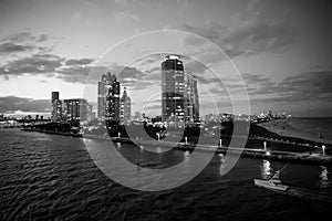 Miami skyscrapers with blue cloudy sky, boat sail, Aerial view