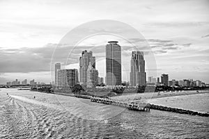 Miami skyscrapers with blue cloudy sky, boat sail, Aerial view