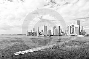 Miami skyscrapers with blue cloudy sky, boat sail, Aerial view