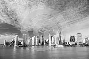 Miami skyscrapers with blue cloudy sky, boat sail, Aerial view