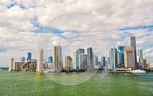 Miami skyscrapers with blue cloudy sky, boat sail, Aerial view