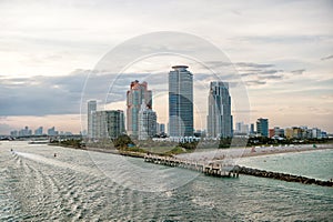 Miami skyscrapers with blue cloudy sky, boat sail, Aerial view