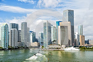 Miami skyscrapers with blue cloudy sky, boat sail, Aerial view