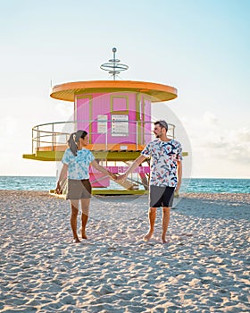 Miami south beach Florida, couple by lifeguard hut during Sunrise Miami Beach