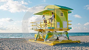 Miami south beach Florida, couple by lifeguard hut during Sunrise Miami Beach