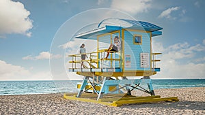 Miami south beach Florida, couple by lifeguard hut during Sunrise Miami Beach