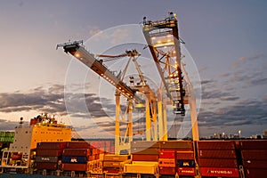 Miami, USA - March 01, 2016: cranes and cargo containers stacked in port. Container port or terminal with night