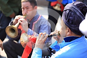 Miao nationality men playing music instrument