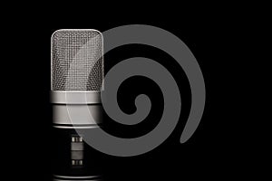 Mic - Close-up of professional condenser microphone on a black isolated background