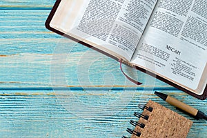 Micah open Holy Bible Book on a rustic wooden table background