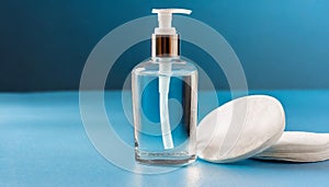 Micellar cleansing gel, cotton buds, cotton pads on blue background. Delicate cleansing everyday photo