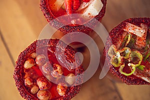 Michelada beer with tomato juice. Clamato with beer on wooden table. Mexican drink. Mexican food. photo