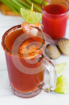 Michelada beer with tomato juice, shrimps, and lemon, mexican drink cocktail in mexico