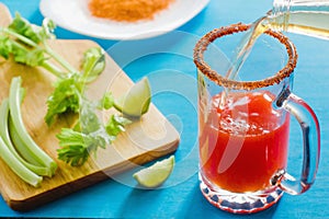 Michelada is beer with tomato juice, spicy sauce and lemon, mexican drink cocktail in mexico