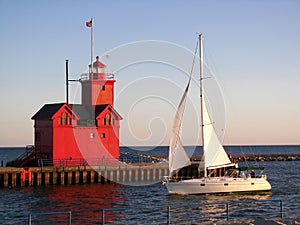 Michigan red lighthouse with sailboat