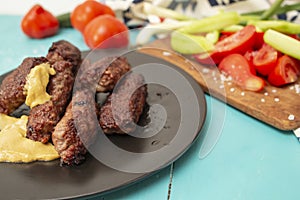 Mici, mititei or Kebapche Cevapcici with vegetables