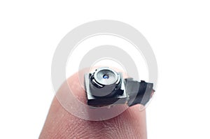 Micro camera for violating the privacy of people less than a personÃ¢â¬â¢s finger on a white background