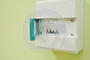 Micro Circuit Breaker or electrical breaker and consumer unit or fuse box on green wall