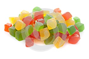 Micro close-up and details of Organic Indian red yellow green mixed color tutti frutti sweet soft candy  isolated over white backg photo