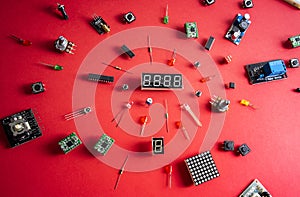 Micro electronics arduino DIY components over red background, top view