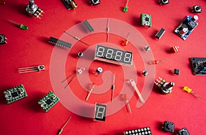 Micro electronics arduino DIY components over red background, top view