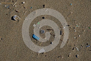 Micro Plastic sea pollution on sandy beach ecosystem,garbage on sea coast