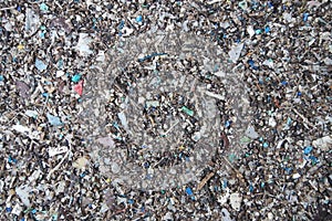 Micro plastics marine debris on sand beach photo