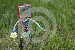 Micro robot in grass on summer nature