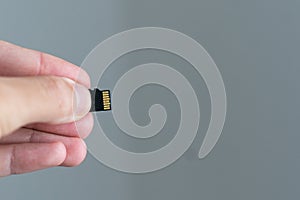 A micro sd card on female finger 