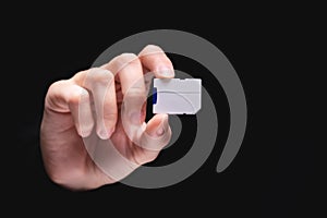 Micro SD memory card adapter on background. front view close up adapter in hand