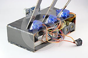 Micro servos or plastic servo motors are connected to a breadboard and micro controller using jumper wires in an interactive