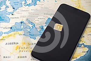 Micro SIM card and smartphone on the world map