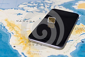 Micro SIM card and smartphone on the world map