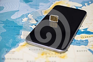 Micro SIM card and smartphone on the world map