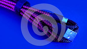 Micro USB cable on blue background.