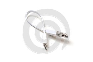Micro usb white cable put on wooden table, it is small and short For portability. isolated on white background
