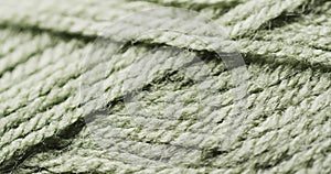 Micro video of close up of green woolly threads with copy space