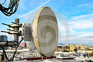 Micro wave radio telecommunication network dish antenna mounted on a metal pole providing transmission strong signal waves